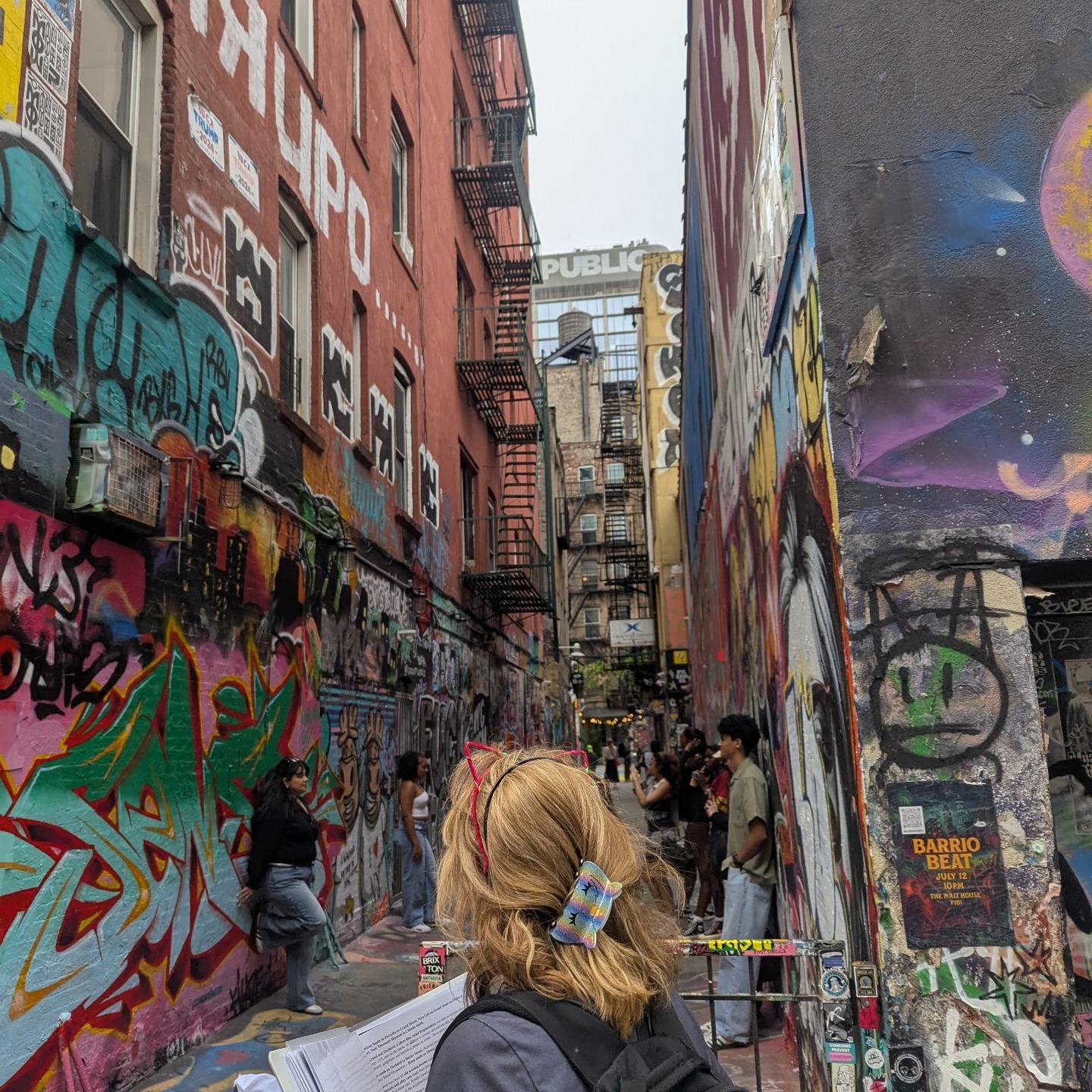 Tour group exploring Freeman Alley graffiti art on Lower East Side