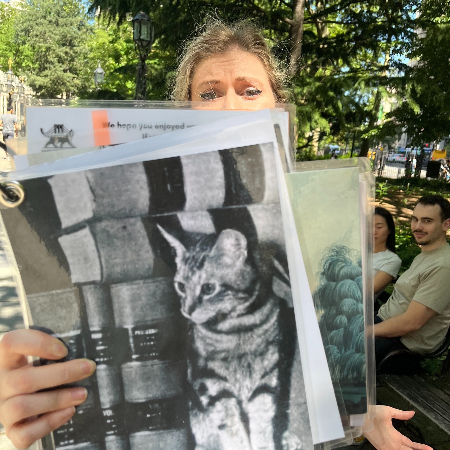 Guide showing historic library cat photo to tour guests