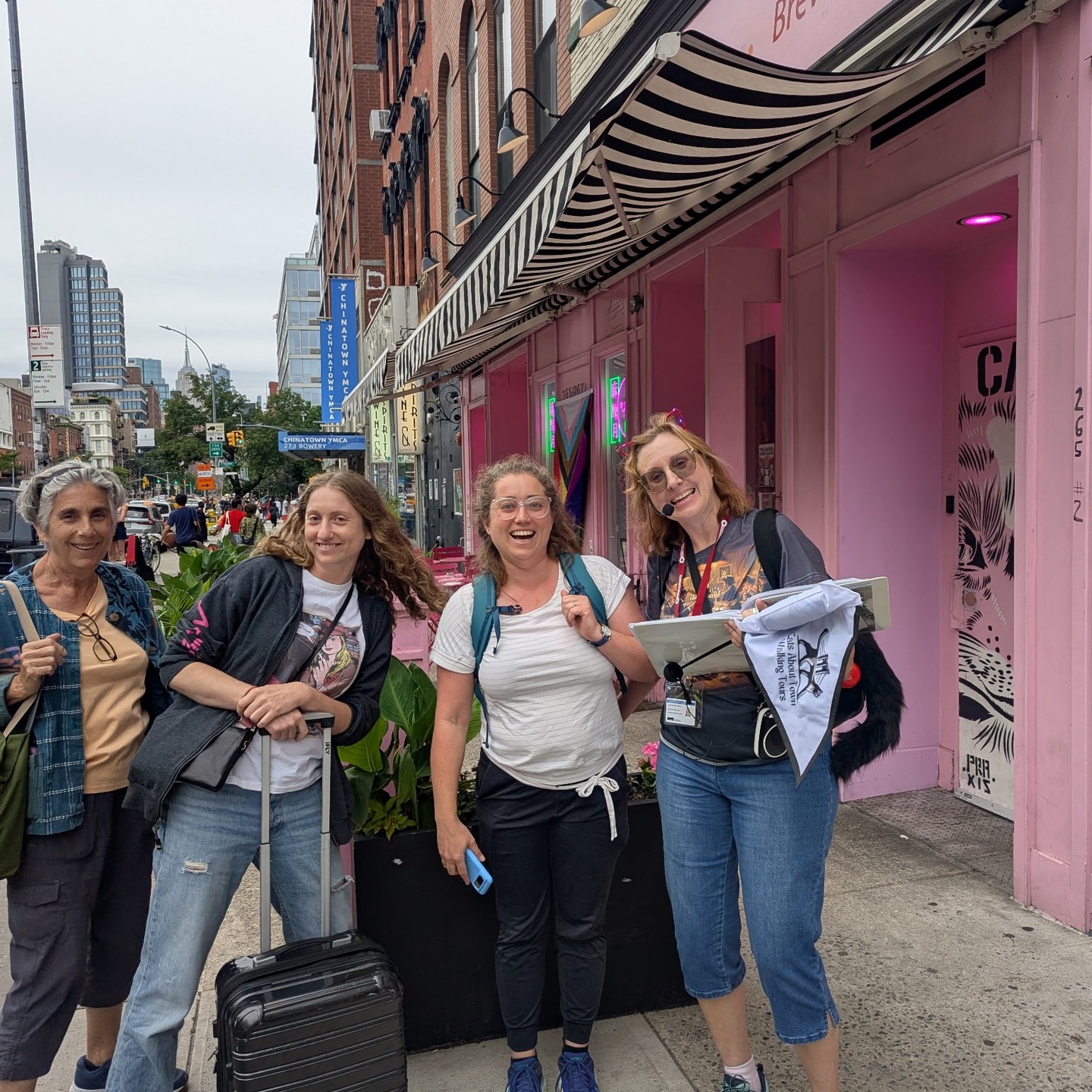 Happy tour guests posing with guide on the Lower East Side