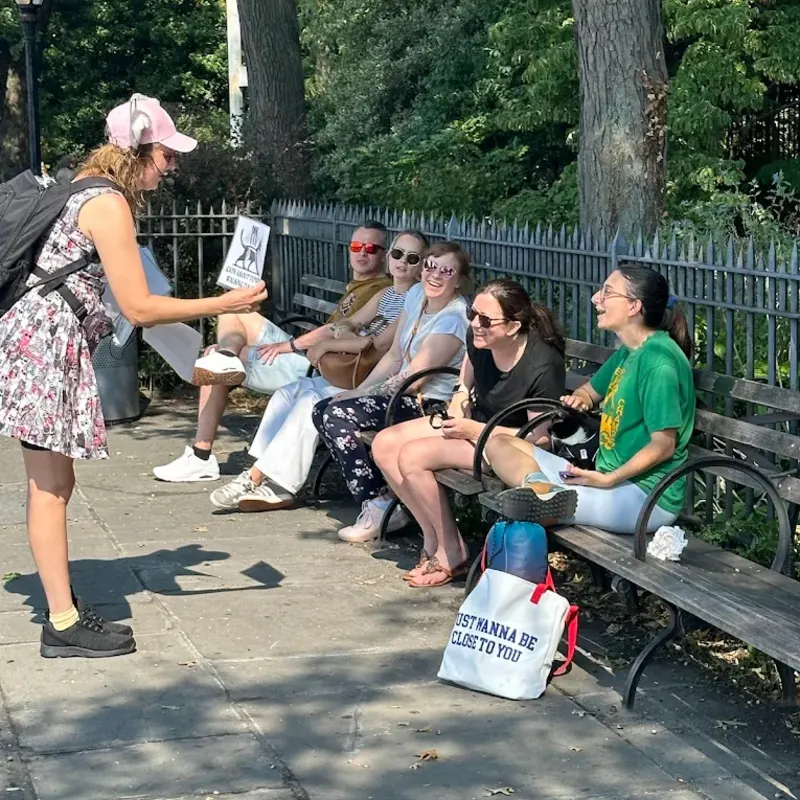 Walking tour group viewing historical materials in NYC
